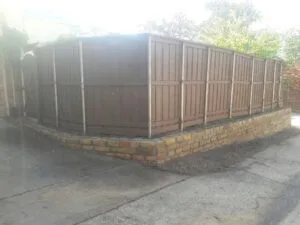 Granbury Stone Retaining Wall with Fence — Dallas TX Dallas retaining wall contractor