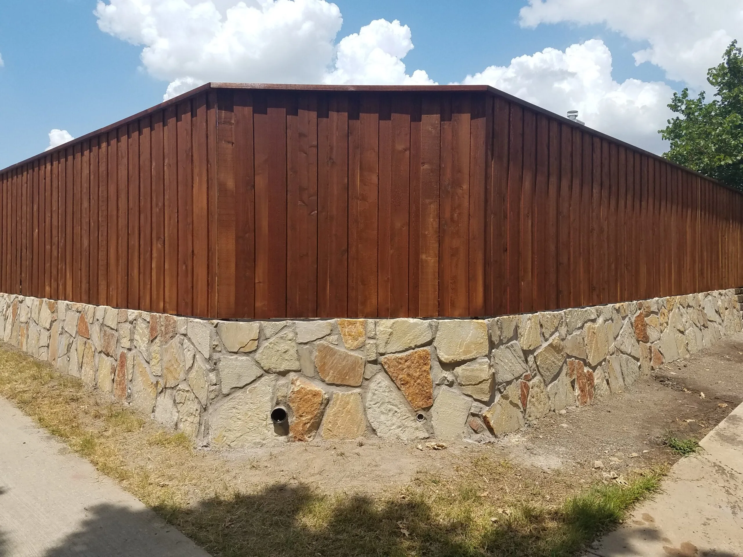 Stone Retaining Wall Under Cedar Fence | Colleyville TX Retaining wall replacement 1
