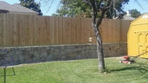 Stone Retaining Wall with Fence Support | Keller TX retaining wall fence