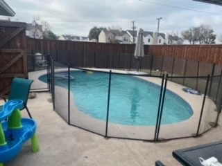 Fenced backyard inground pool with concrete decking in DFW suburb, candidate for partial pool removal and demolition service