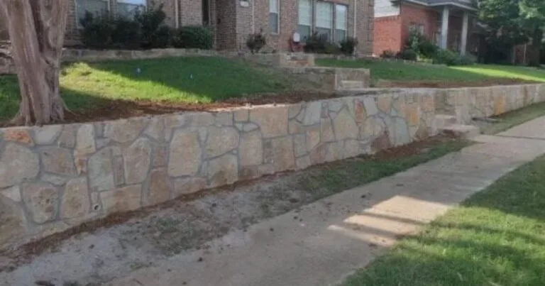 Tiered Granbury stone retaining wall replacing old crosstie wall along residential front yard in Arlington, TX