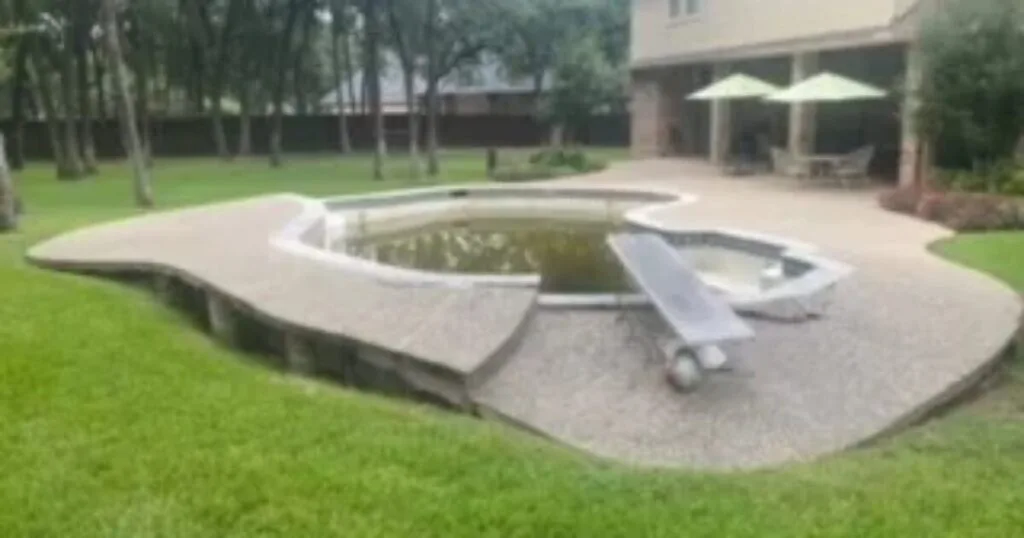 Neglected inground pool with dark stagnant water and deteriorating concrete deck awaiting complete removal at a Keller TX residential property