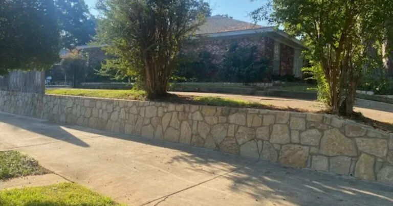 New Milsap stone retaining wall along a residential sidewalk in Arlington TX, raising and leveling a brick-home front yard