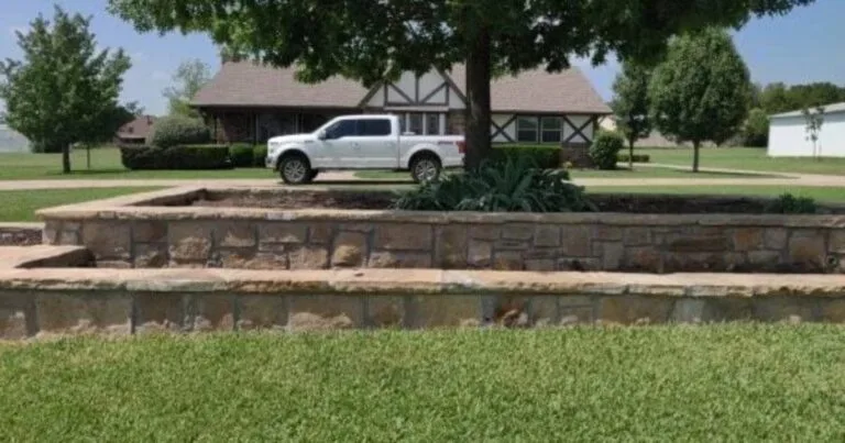 Two-tier Milsap stone retaining wall with flagstone cap replacing old crosstie wall at a Keller TX home