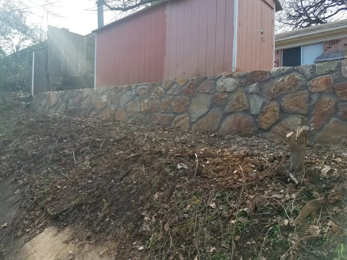 Fieldstone drainage retaining wall — a JCL Landscape Services project in the Dallas–Fort Worth metroplex