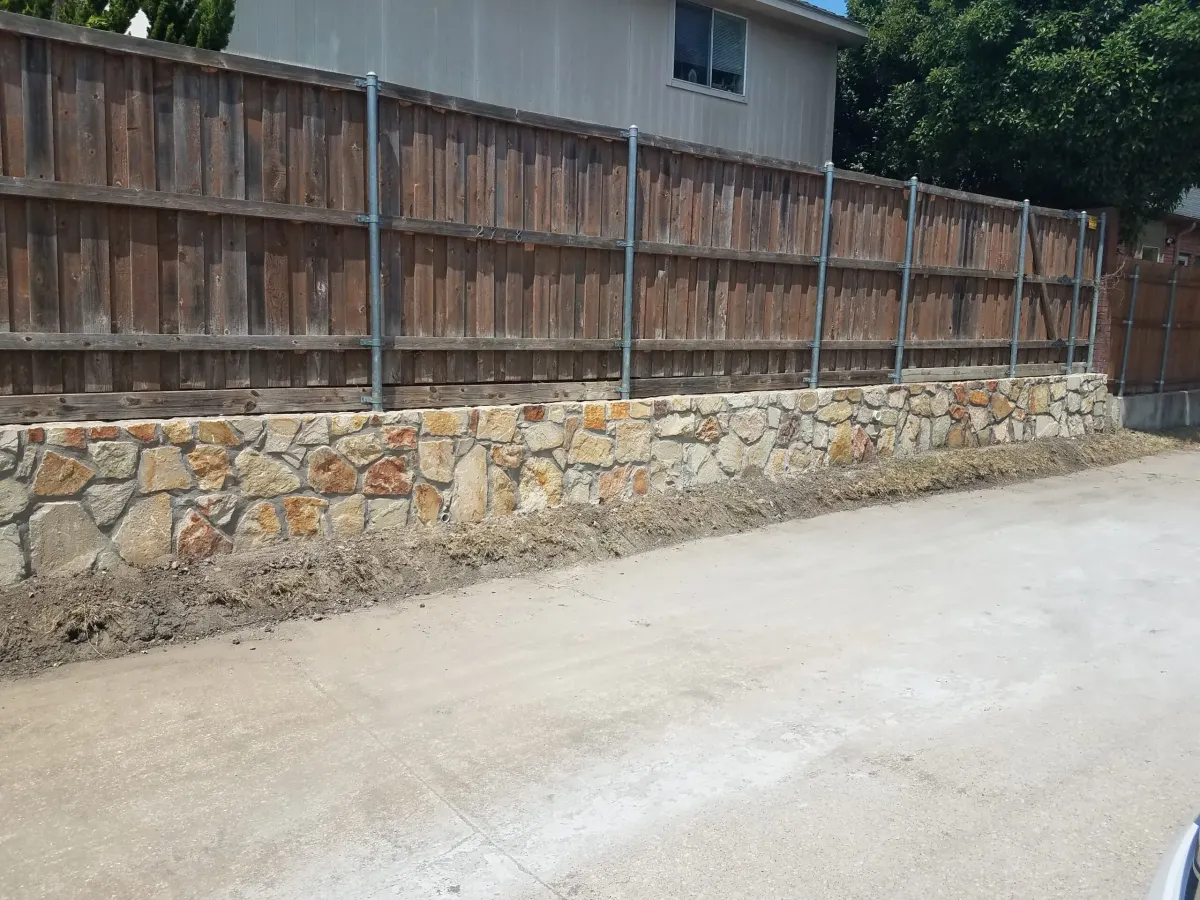 Granbury stone retaining wall fence — a JCL Landscape Services project in the Dallas–Fort Worth metroplex
