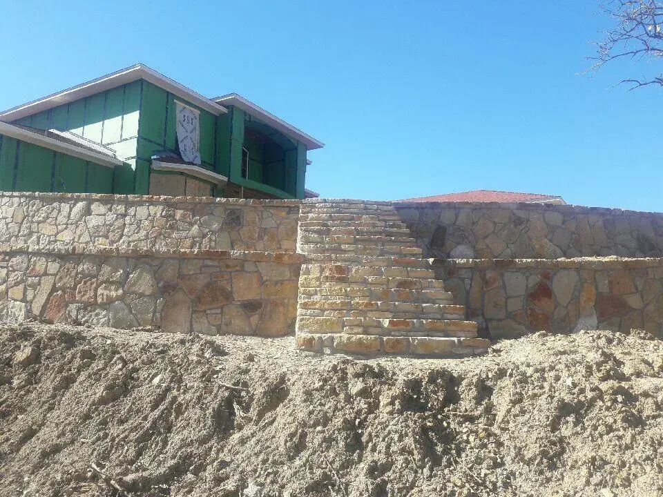 Natural stone retaining wall steps — a JCL Landscape Services project in the Dallas–Fort Worth metroplex