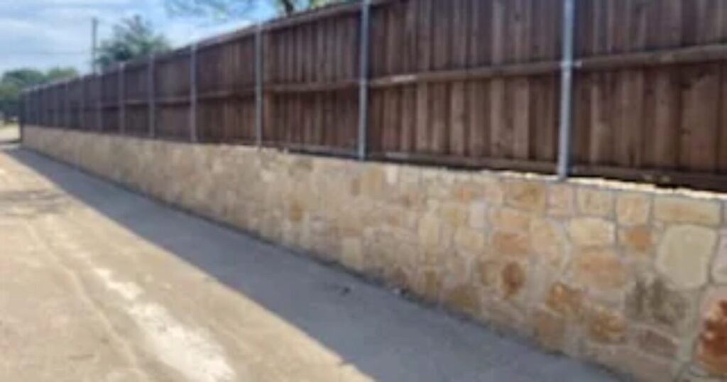 Replacing a railroad tie wall with a natural stone wall in Plano TX