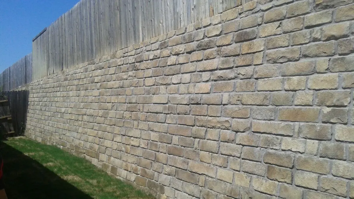 Stone block retaining wall repair — a JCL Landscape Services project in the Dallas–Fort Worth metroplex