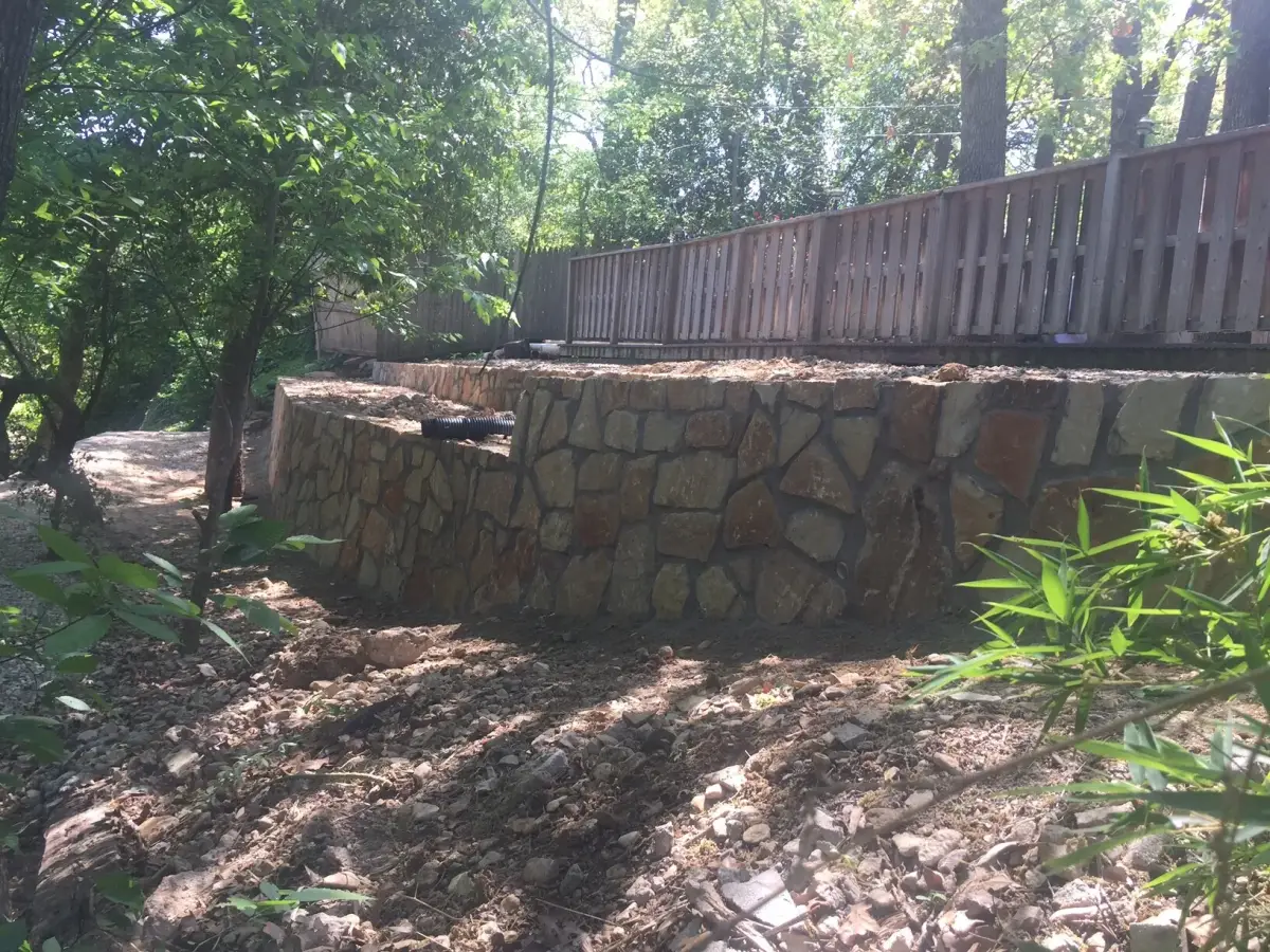 Terraced stone retaining wall drainage — a JCL Landscape Services project in the Dallas–Fort Worth metroplex