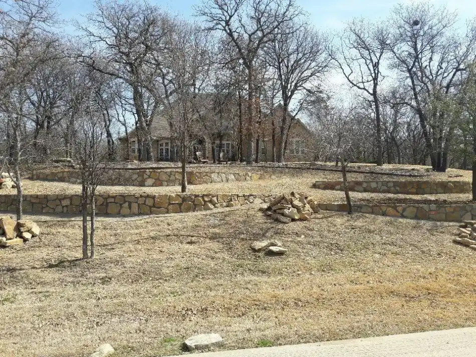 Tiered stone retaining walls sloped yard — a JCL Landscape Services project in the Dallas–Fort Worth metroplex Tiered stone retaining walls sloped yard — a JCL Landscape Services project in the Dallas–Fort Worth metroplex