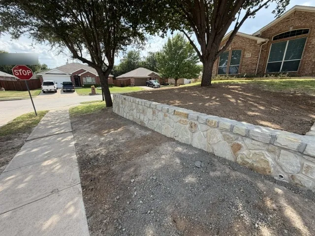 New mortared Milsap stone retaining wall beside the sidewalk on a Benbrook, TX corner lot